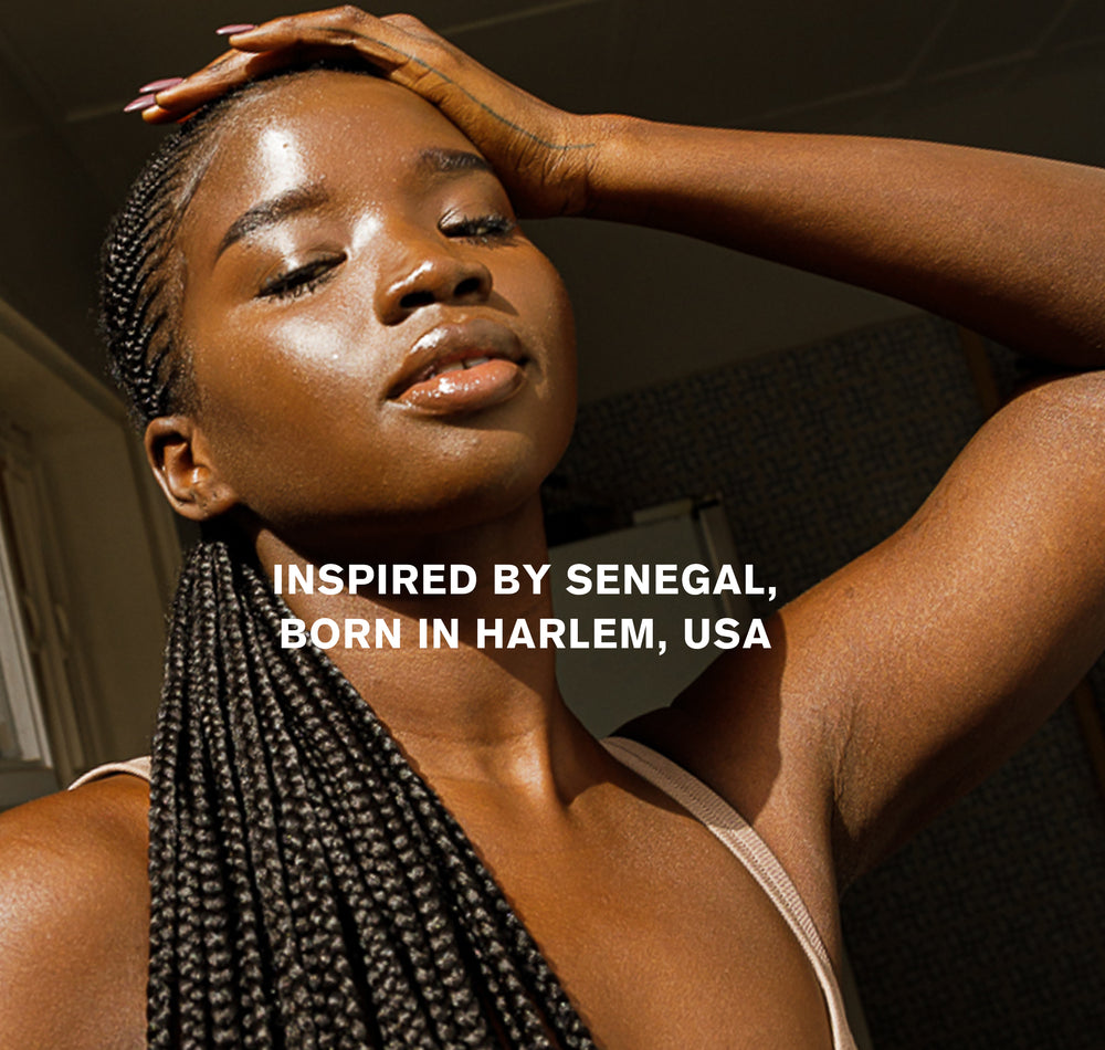 Woman holding her hair - "Inspired by Senegal, born in Harlem, USA"